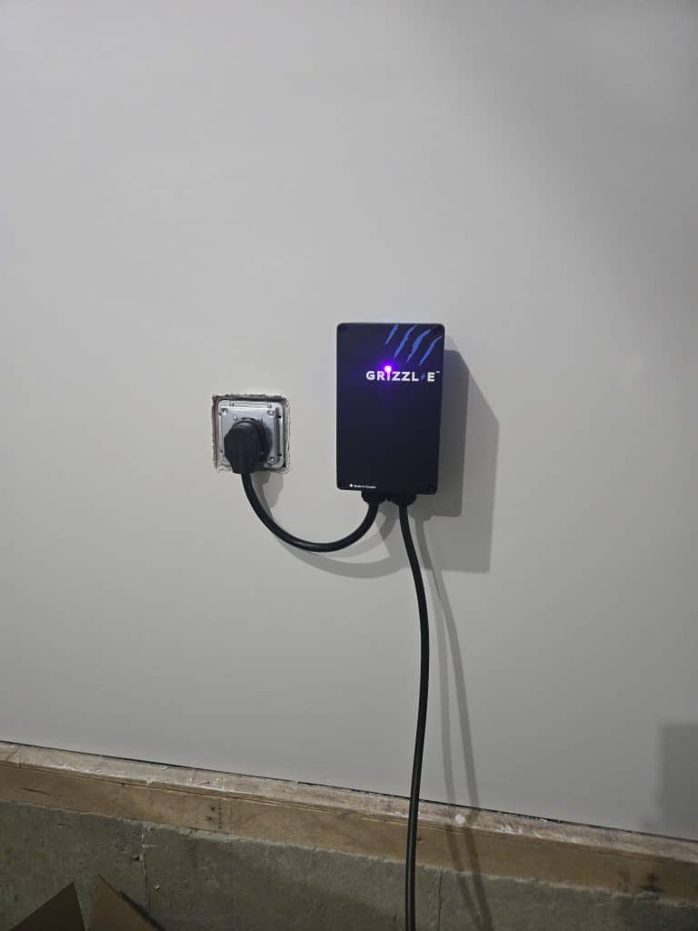 Grizzl‑E EV Charger installed and plugged in